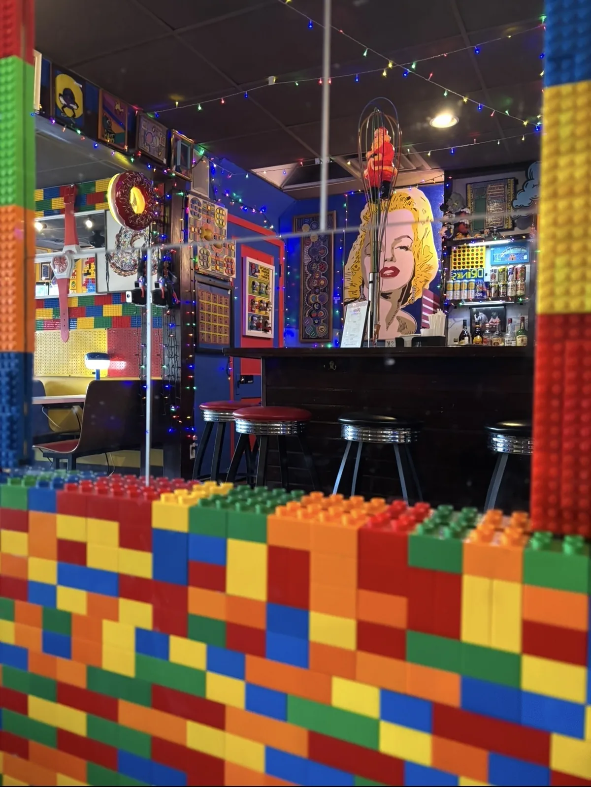 The Happy Dough Lucky bar seen over a wall built from Lego bricks